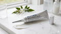 Lucenci Reform Brightening Cream tube on a marble surface with botanicals